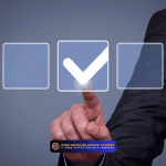 Hand pointing toward a digital checkmark icon, representing action steps and making referrals effortless.